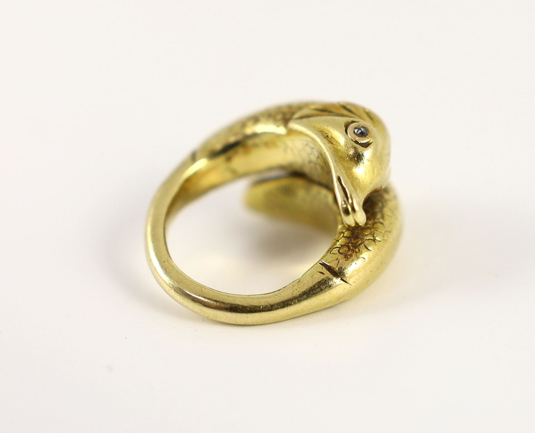 An early 20th century continental gold and diamond chip set twin dolphin crossover ring